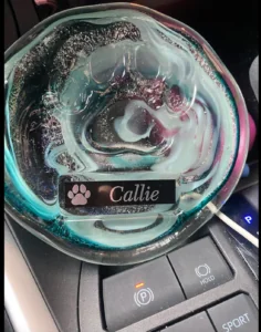 A glass disc with the name Callie on it